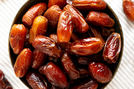 Organic Raw Dry Dates in a Bowl, top view. Close-up.