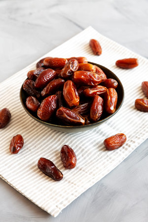 Organic Raw Dry Dates in a Bowl, side view.