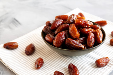 Organic Raw Dry Dates in a Bowl, side view.