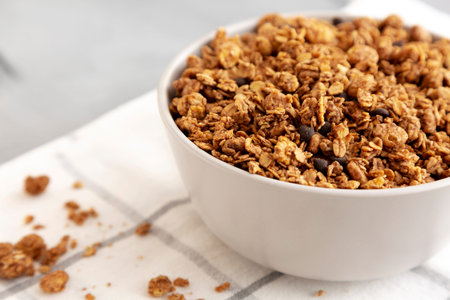 Tasty Homemade Chocolate Granola in a Bowl, side view. Close-up.