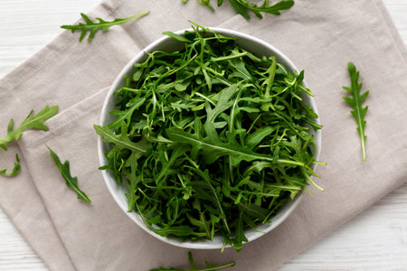 Organic Raw Green Arugula in a Bowl, top view. Overhead, from above.