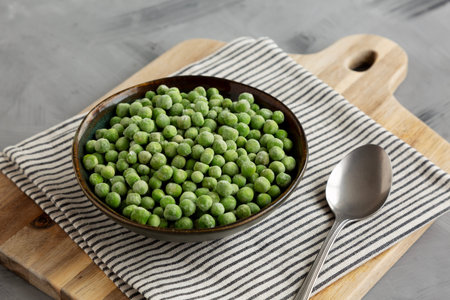 Organic Frozen Green Peas in a Bowl, side view.