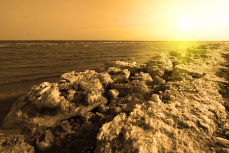 frozen sandy beach natural scenery in a geological park, north chinaの写真素材
