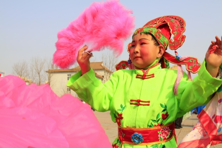 LUANNAN COUNTY - FEBRUARY 23  During the Chinese Lunar New Year, people wear colorful clothes, yangko dance performances in the streets, on February 23, 2013, Luannan County, Hebei Province, China のeditorial素材