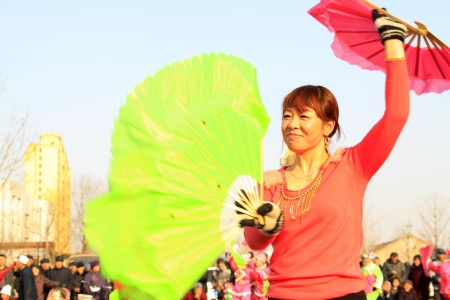 LUANNAN COUNTY - FEBRUARY 22  During the Chinese Lunar New Year, people wear colorful clothes, yangko dance performances in the street, on February 22, 2013, Luannan County, Hebei Province, China のeditorial素材