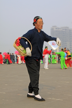 LUANNAN COUNTY - FEBRUARY 22  During the Chinese Lunar New Year, people wear colorful clothes, yangko dance performances in the streets, on February 22, 2013, Luannan County, Hebei Province, China のeditorial素材