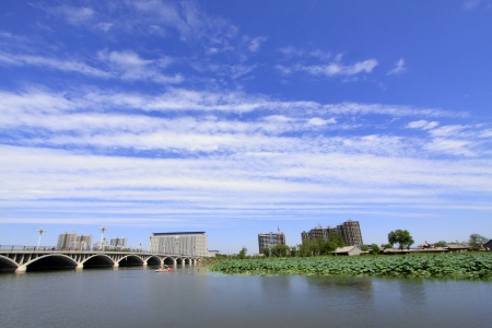 Wide water surface and buildings in a parkの写真素材