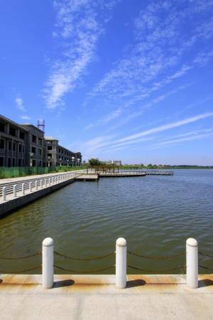 Wide water surface and high rise buildings in a parkの写真素材