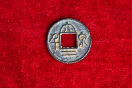 chinaese ancient money on the red background, closeup of photo