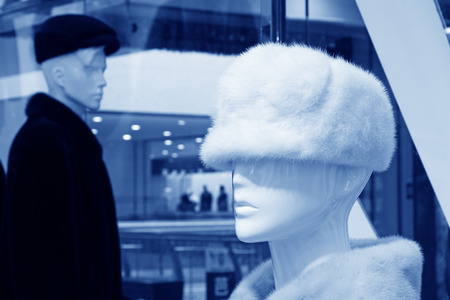 model wearing fur hat in a shop