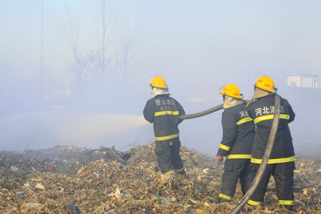 TANGSHAN - NOVEMBER 20: The words "Hebei fire" and "tangshan fire" on the clothes, the fireman at the scene of the fire, November 20, 2013, tangshan city, hebei province, China. のeditorial素材