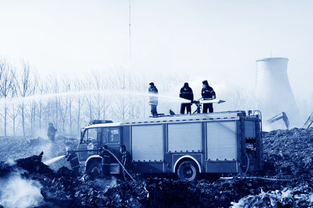 TANGSHAN - NOVEMBER 20: firefighters in sprinkler at the scene of the fire, November 20, 2013, tangshan city, hebei province, China. のeditorial素材