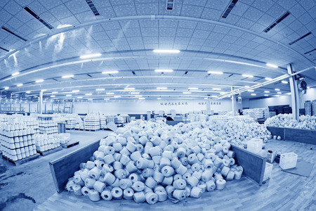 LUANNAN COUNTY - DECEMBER 20: The cotton reel thread piled up together in a production workshop, in the ZeAo spinning LTD., on December 20, 2013, Luannan county, hebei province, China. のeditorial素材