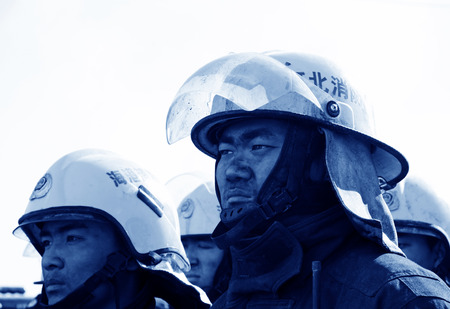 TANGSHAN - NOVEMBER 20: The firemen preparing to leave the fire scene after the fire, November 20, 2013, tangshan city, hebei province, China. のeditorial素材