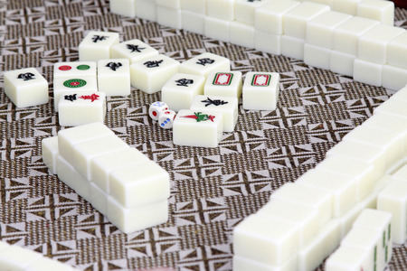 closeup of mahjong tiles in a desk