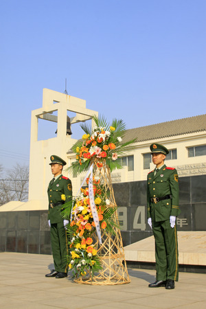 LUANNAN COUNTY - MARCH 22: Armed police soldiers carrying flower basket, in Pan Dai village massacre memorial building exterior, on March 22, 2014, luannan county, hebei province, China
のeditorial素材