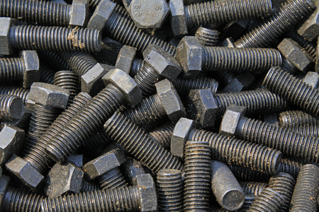 bolts piled up together, closeup of photo