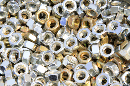 new screw nut piled up together, closeup of photo