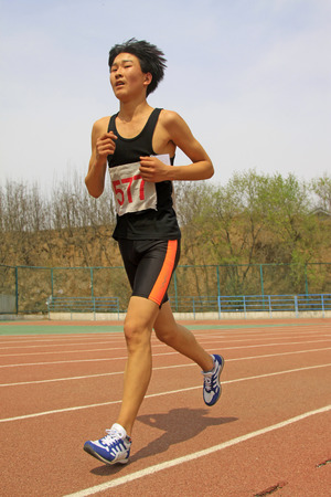 LUANNAN COUNTY - APRIL 10: 3000 m distance runner runing on the playground in a school, on April 10, 2014, Luannan county, hebei province, China. 
のeditorial素材