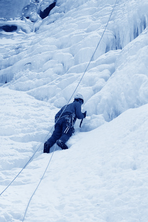 QINGLONG - JANUARY 18: The ice climbing enthusiasts use rope, climbing a frozen waterfall, on January 18, 2014, QingLong, hebei province, China. のeditorial素材