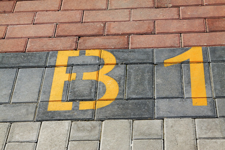 yellow numbers on color cement block, closeup of photoの写真素材