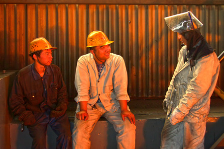 TANGSHAN - JUNE 18: workers have a short rest, in a iron and steel co., on June 18, 2014, Tangshan...