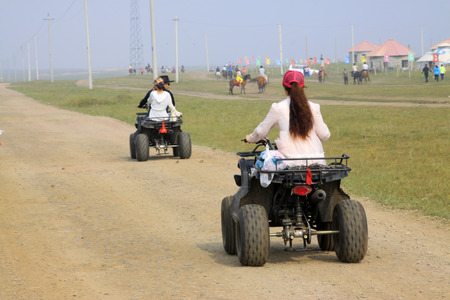 WULANBUTONG GRASSLAND - JULY 19: marching four-wheel off-road motorcycles in the WuLanBuTong grassland on July 19, 2014, Inner Mongolia autonomous region, China. 
のeditorial素材