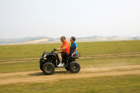 WULANBUTONG GRASSLAND - JULY 19: marching four-wheel off-road motorcycles in the WuLanBuTong grassland on July 19, 2014, Inner Mongolia autonomous region, China. 
のeditorial素材