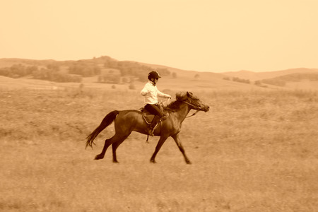 WULANBUTONG GRASSLAND - JULY 19: Speeding horse and knights in the WuLanBuTong grassland, on July 19, 2014, Inner Mongolia autonomous region, China. のeditorial素材