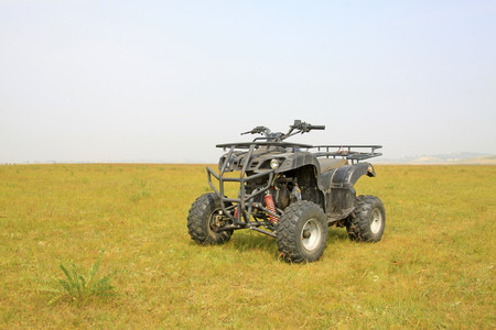 four wheels motorcycle on the grassland, closeup of photo