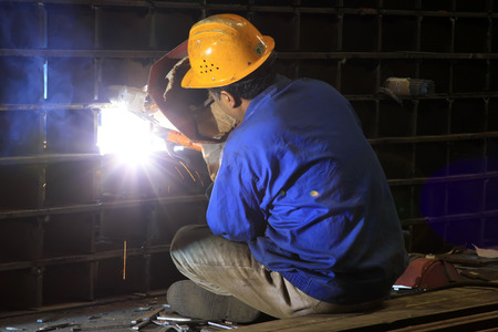 TANGSHAN CITY - JUNE 20: Worker welding parts in the production workshop, on June 20, 2014, Tangshan...