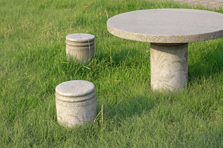 stone table and chair in the park, closeup of photoの写真素材