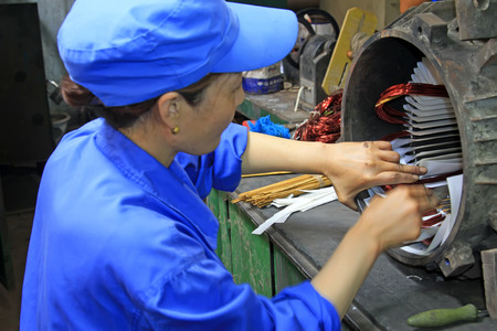 TANGSHAN - JUNE 19: Women workers repairing electrical machine in a factory, on June 19, 2014, Tangshan city, Hebei Province, China
のeditorial素材