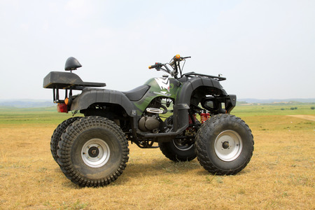 four wheels motorcycle on the grassland, closeup of photo