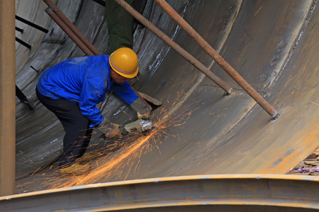 TANGSHAN - JUNE 20: Workers are welding metal components in a steel plant, on June 20, 2014,...