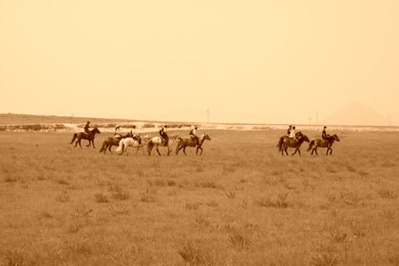WULANBUTONG GRASSLAND - JULY 19: Travelers on horseback in the WuLanBuTong grassland on July 19, 2014, Inner Mongolia autonomous region, China. 
のeditorial素材