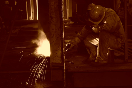 TANGSHAN CITY - JUNE 20: Worker welding parts in the production workshop, on June 20, 2014, Tangshan...