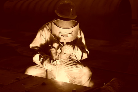TANGSHAN CITY - JUNE 20: Worker welding parts in the production workshop, on June 20, 2014, Tangshan...