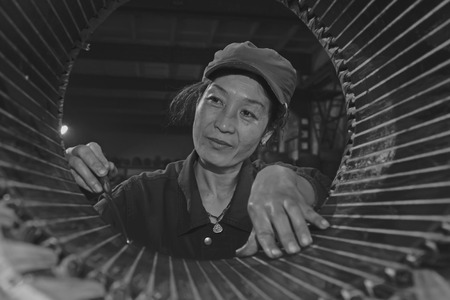 TANGSHAN - JUNE 20: Women workers repairing electrical machine in a factory, on June 20, 2014, Tangshan city, Hebei Province, Chinaのeditorial素材