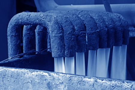 water flowing from pipe in industrial high pressure equipment, closeup of photo
の写真素材