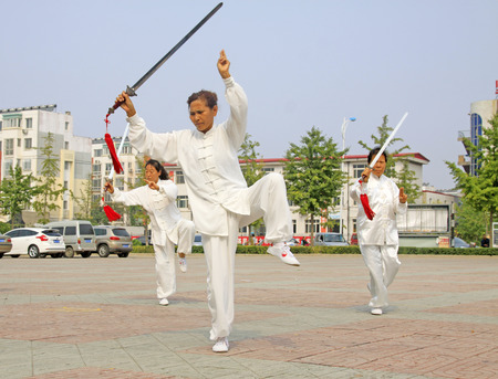 LUANNAN COUNTY - SEPTEMBER 20: Old women Fencing performance in a square on September 20, 2014, Luannan county, Hebei Province, Chinaのeditorial素材