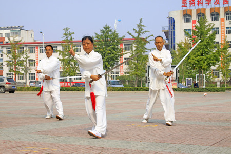 LUANNAN COUNTY - SEPTEMBER 20: Old men Fencing performance in a square on September 20, 2014, Luannan county, Hebei Province, Chinaのeditorial素材