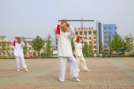 LUANNAN COUNTY - SEPTEMBER 20: Old men fencing performance in a square on September 20, 2014,...