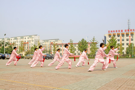 LUANNAN COUNTY - SEPTEMBER 20: Old women Fencing performance in a square on September 20, 2014, Luannan county, Hebei Province, Chinaのeditorial素材