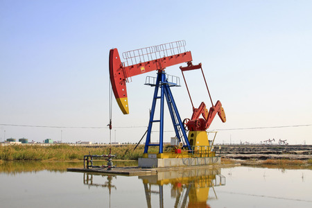 CAOFEIDIAN - SEPTEMBER 27: crank balanced beam pumping unit in the JiDong oilfield, on September 27, 2014, Caofeidian City, hebei province, China.の写真素材