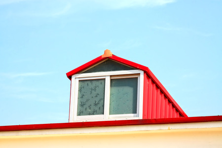 Red attic window, closeup of photoの写真素材