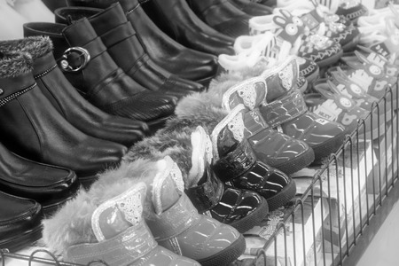 TANGSHAN - NOVEMBER 16: Shoes were put on the shelf in a store, on November 16, 2013, tangshan city, hebei province, China.の写真素材