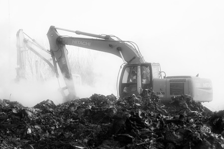 TANGSHAN - NOVEMBER 20: The excavators were clearing up rubbish after fire, November 20, 2013, tangshan city, hebei province, China.のeditorial素材