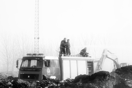 TANGSHAN - NOVEMBER 20: firefighters in sprinkler at the scene of the fire, November 20, 2013,...