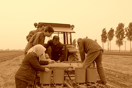 Luannan County, May 7: Farmers use new agricultural machinery sowing peanut in ShuangLiu Tree...